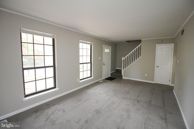 unfurnished living room featuring stairs, ornamental molding, carpet floors, and baseboards