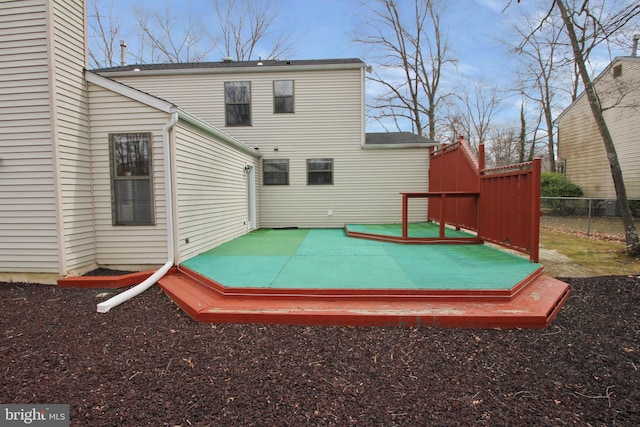 back of property featuring fence and a deck