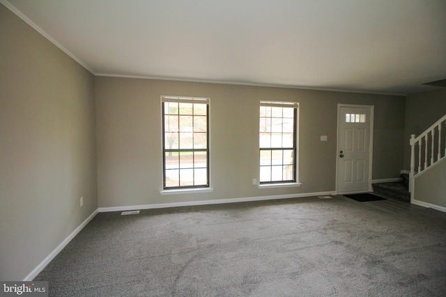 entryway with ornamental molding, stairway, carpet flooring, and baseboards