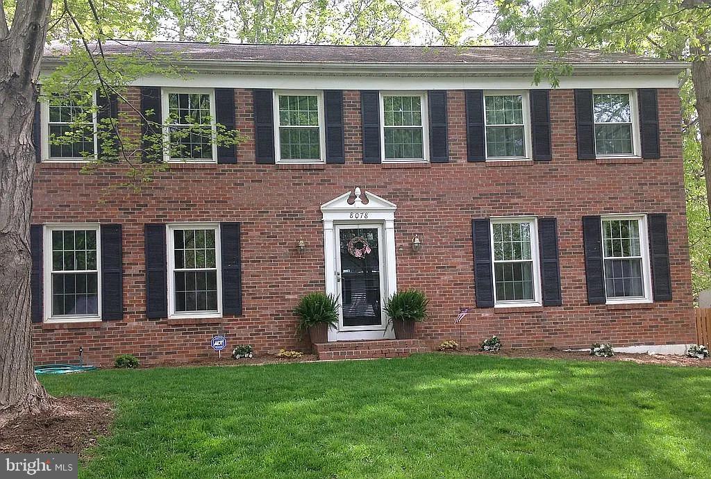 view of front of property with a front yard and brick siding