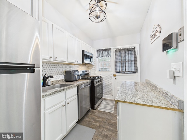 8663 Black Oak, Baltimore, MD 21234 - kitchen featuring stainless steel appliances, a sink, white cabinets, and backsplash