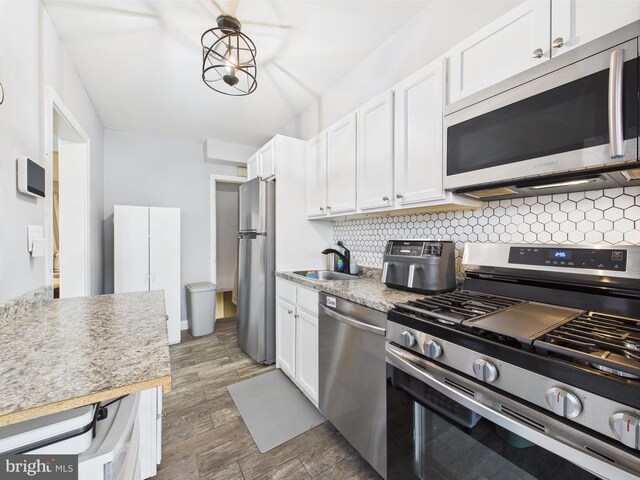 8663 Black Oak, Baltimore, MD 21234 - kitchen featuring appliances with stainless steel finishes, a sink, tasteful backsplash, and white cabinets