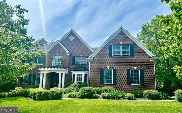 115 Hartefeld Dr, Avondale, PA 19311 - view of front facade featuring brick siding and a front yard