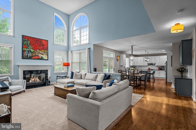 115 Hartefeld Dr, Avondale, PA 19311 - living room with dark wood-style flooring, a fireplace with flush hearth, and a towering ceiling