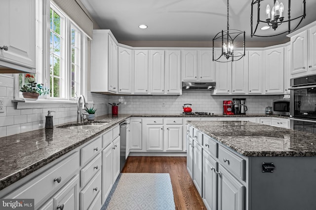 115 Hartefeld Dr, Avondale, PA 19311 - kitchen with a chandelier, a sink, white cabinetry, appliances with stainless steel finishes, and recessed lighting