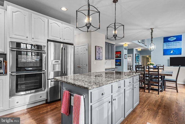 115 Hartefeld Dr, Avondale, PA 19311 - kitchen featuring stainless steel appliances, stone counters, decorative light fixtures, dark wood finished floors, and recessed lighting