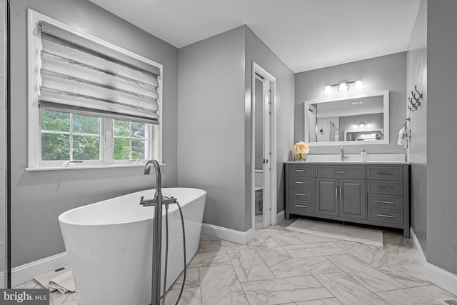 115 Hartefeld Dr, Avondale, PA 19311 - full bathroom featuring marble look tile flooring, baseboards, toilet, a soaking tub, and vanity