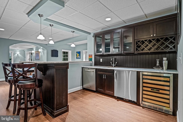 115 Hartefeld Dr, Avondale, PA 19311 - indoor wet bar featuring wine cooler, dishwasher, baseboards, light wood-style floors, and hanging light fixtures