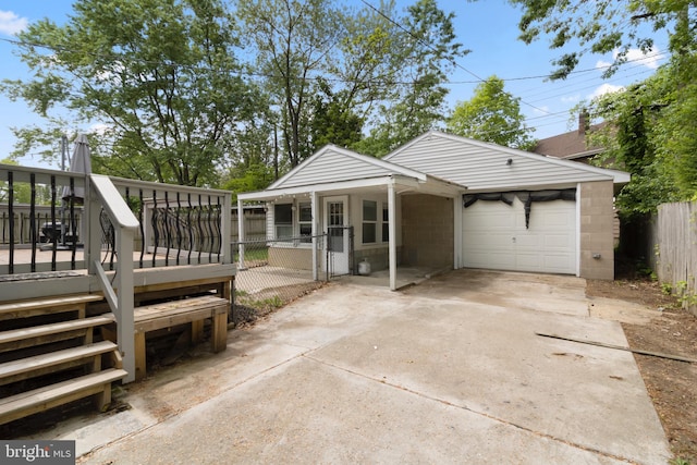 294 Jefferson St, Carneys Point, NJ 08069 - view of front facade featuring fence, concrete block siding, concrete driveway, and a wooden deck