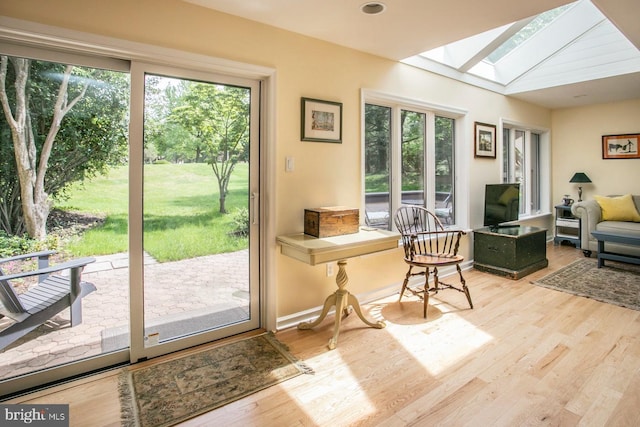 entryway with a skylight and wood finished floors