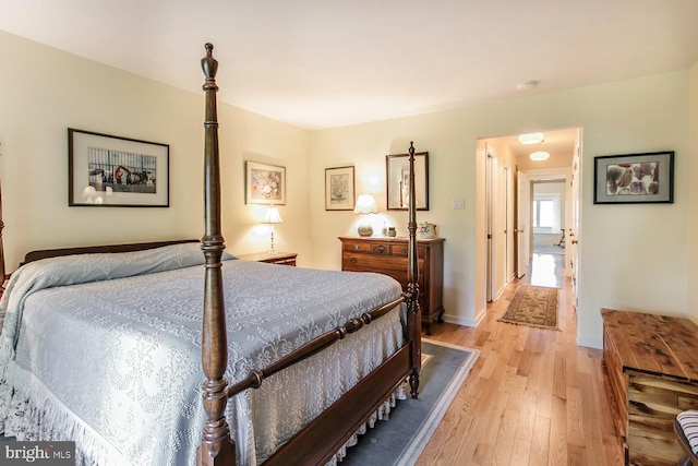 bedroom featuring light wood-type flooring and baseboards