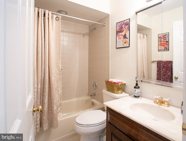full bath with toilet, shower / bath combo with shower curtain, and vanity