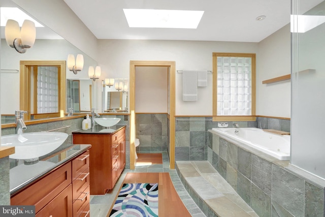 618 20th St S, Arlington, VA 22202 - full bath with two vanities, a skylight, a jetted tub, and tile walls
