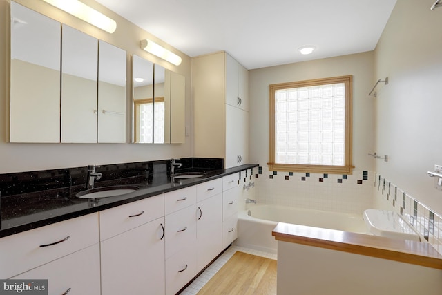 618 20th St S, Arlington, VA 22202 - full bathroom with double vanity, a bath, and wood finished floors