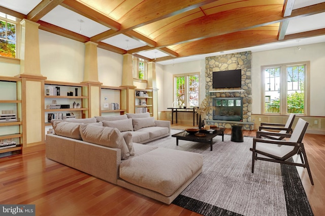 618 20th St S, Arlington, VA 22202 - living area featuring wood-type flooring, coffered ceiling, beamed ceiling, a fireplace, and healthy amount of natural light