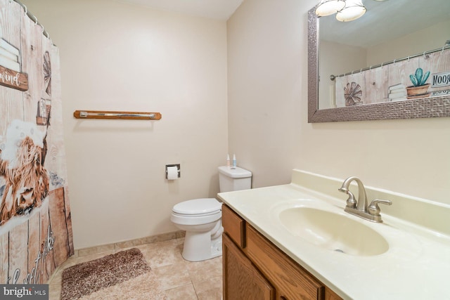 101 George St, Taneytown, MD 21787 - bathroom featuring vanity, toilet, tile patterned flooring, and baseboards