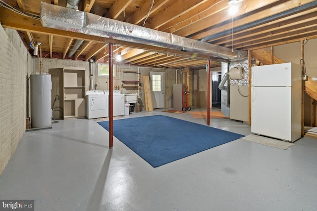 101 George St, Taneytown, MD 21787 - basement featuring freestanding refrigerator, water heater, a sink, washer and dryer, and brick wall