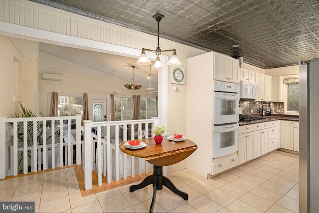 759 Avenue F, Langhorne, PA 19047 - kitchen featuring appliances with stainless steel finishes, an ornate ceiling, dark countertops, a wall mounted AC, and light tile patterned floors