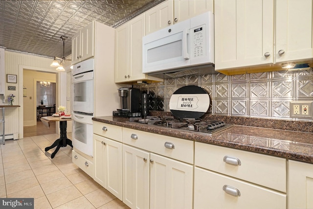 759 Avenue F, Langhorne, PA 19047 - kitchen with white appliances, light tile patterned flooring, tasteful backsplash, an ornate ceiling, and white cabinetry