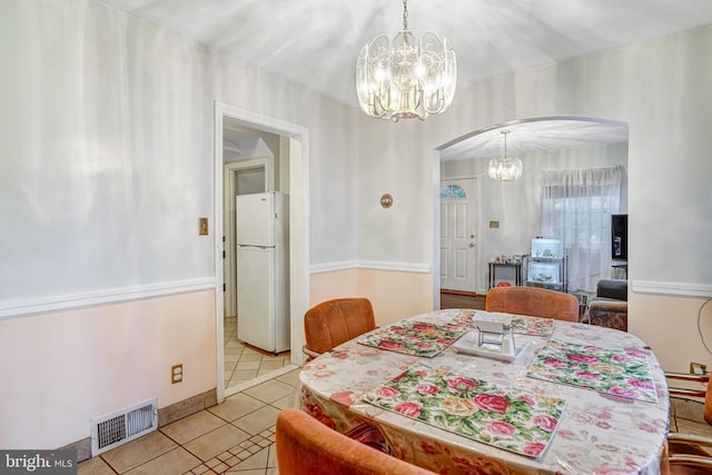 102 S Glebe Rd S, Arlington, VA 22204 - dining space with arched walkways, a chandelier, and light tile patterned floors