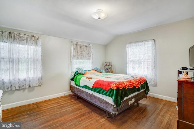 102 S Glebe Rd S, Arlington, VA 22204 - bedroom with multiple windows, wood finished floors, vaulted ceiling, and baseboards