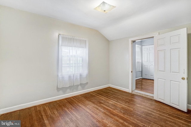 102 S Glebe Rd S, Arlington, VA 22204 - unfurnished bedroom with vaulted ceiling, baseboards, and wood finished floors