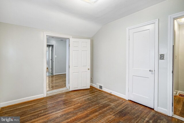102 S Glebe Rd S, Arlington, VA 22204 - unfurnished bedroom featuring lofted ceiling, wood finished floors, and baseboards