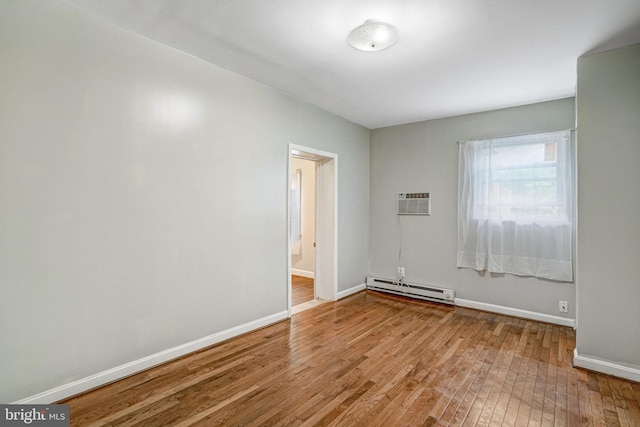 102 S Glebe Rd S, Arlington, VA 22204 - unfurnished room featuring a baseboard radiator, hardwood / wood-style flooring, baseboards, and a wall mounted AC