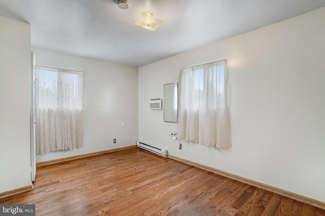 102 S Glebe Rd S, Arlington, VA 22204 - spare room with baseboard heating, plenty of natural light, and light wood-type flooring