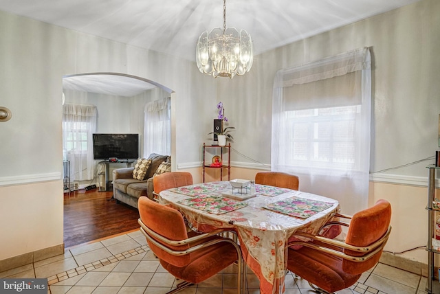102 S Glebe Rd S, Arlington, VA 22204 - dining space featuring light tile patterned floors, arched walkways, and a chandelier