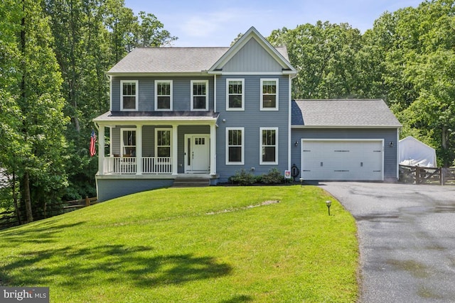 435 Potomac Run Rd, Fredericksburg, VA 22405 - colonial home with a porch, asphalt driveway, an attached garage, board and batten siding, and a shingled roof