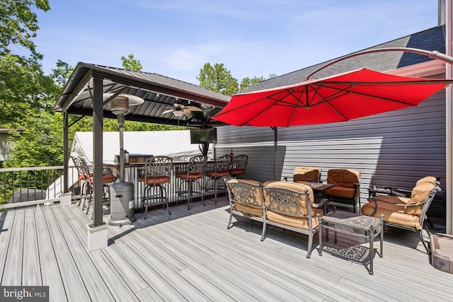 435 Potomac Run Rd, Fredericksburg, VA 22405 - wooden deck with a gazebo, outdoor dining space, and a ceiling fan