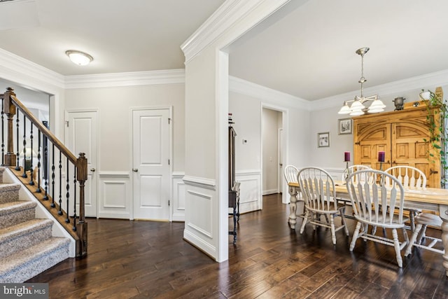 435 Potomac Run Rd, Fredericksburg, VA 22405 - dining space with ornamental molding, a wainscoted wall, stairway, dark wood-style floors, and a chandelier