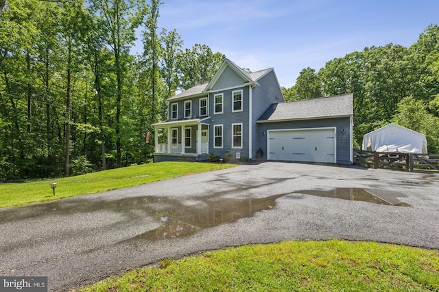 435 Potomac Run Rd, Fredericksburg, VA 22405 - colonial-style house with asphalt driveway, a garage, a porch, and a front lawn