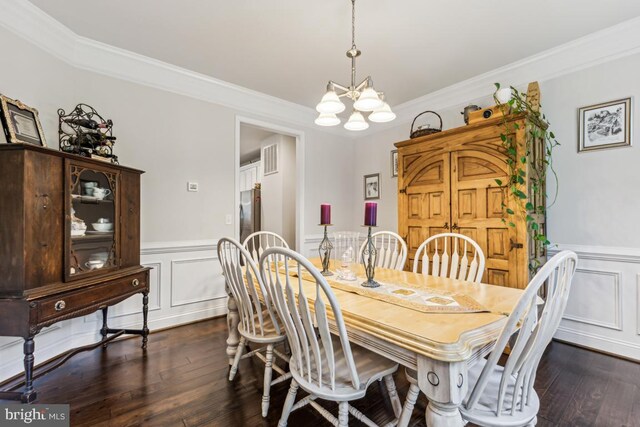 435 Potomac Run Rd, Fredericksburg, VA 22405 - dining room with a chandelier, crown molding, a wainscoted wall, dark wood-style floors, and a decorative wall