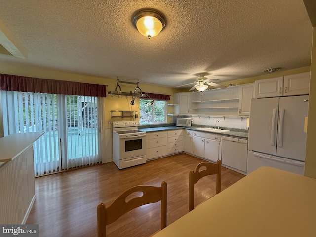 64 Mulberry St, Franklin, WV 26807 - kitchen with white appliances, open shelves, a sink, wood finished floors, and a textured ceiling