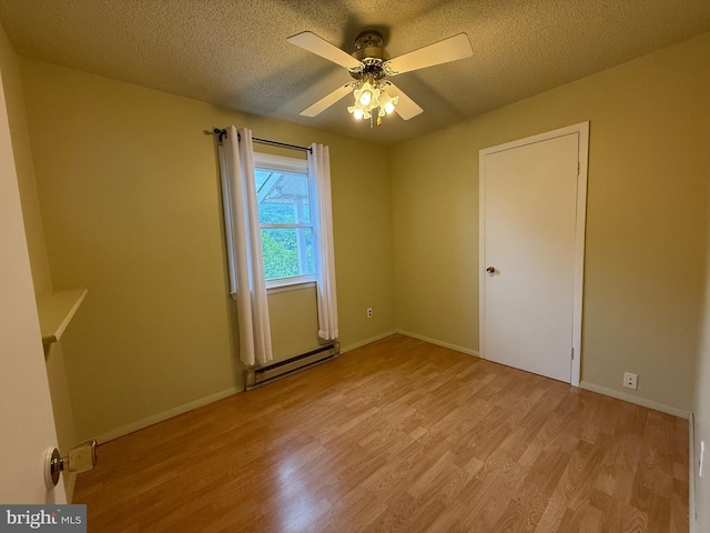 64 Mulberry St, Franklin, WV 26807 - spare room featuring a baseboard radiator, wood finished floors, ceiling fan, a textured ceiling, and baseboards