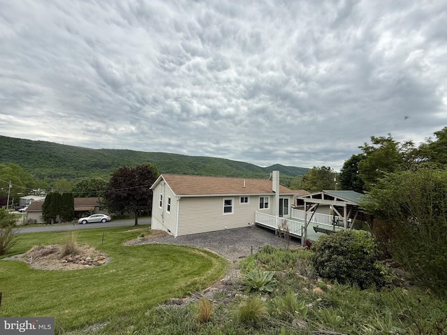 64 Mulberry St, Franklin, WV 26807 - rear view of house featuring a deck with mountain view, a chimney, and a yard