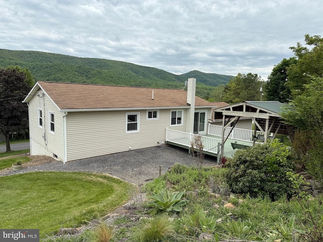 64 Mulberry St, Franklin, WV 26807 - rear view of house featuring a chimney, a deck with mountain view, roof with shingles, and a yard