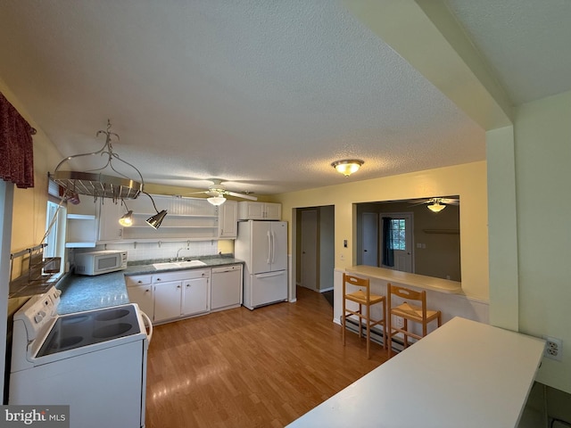 64 Mulberry St, Franklin, WV 26807 - kitchen featuring white appliances, a ceiling fan, light wood finished floors, and a textured ceiling