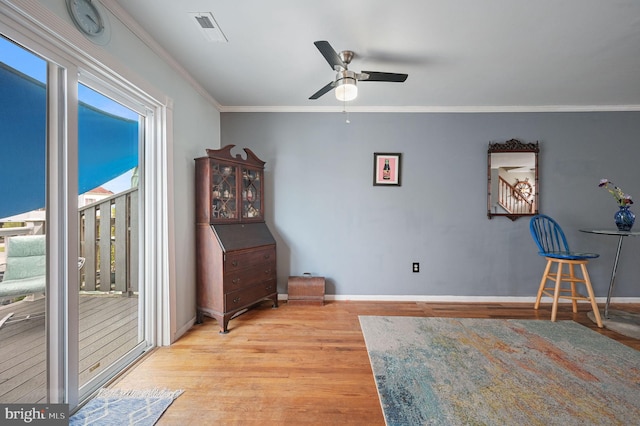 59 Wyatt St, Frederica, DE 19946 - living area with wood finished floors, ceiling fan, baseboards, and ornamental molding