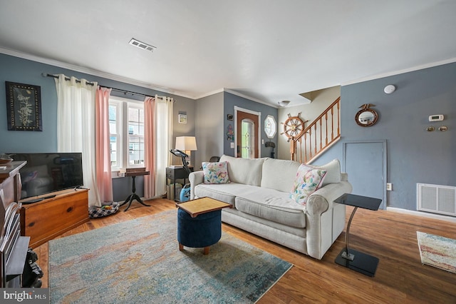 59 Wyatt St, Frederica, DE 19946 - living area featuring stairs, crown molding, wood finished floors, and baseboards