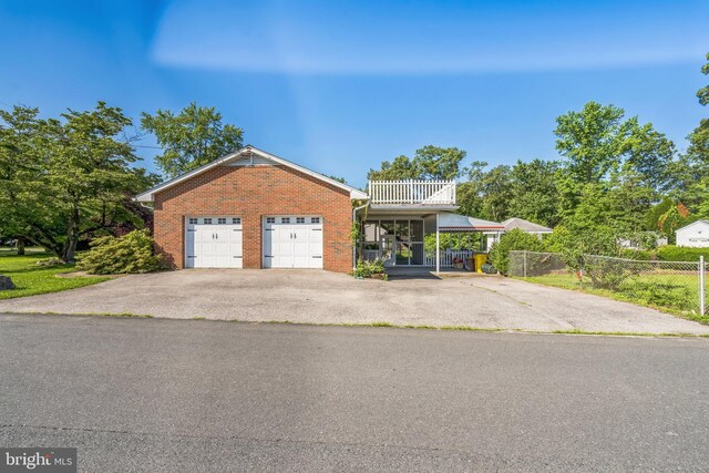 931 Oakdale Cir, Millersville, MD 21108 - view of front facade featuring a balcony, driveway, a garage, and brick siding