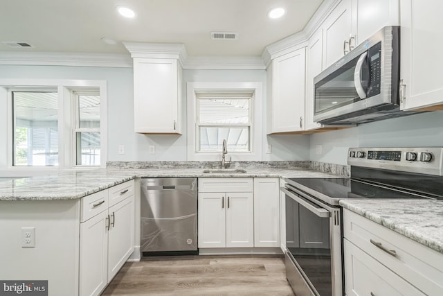 931 Oakdale Cir, Millersville, MD 21108 - kitchen with stainless steel appliances, ornamental molding, plenty of natural light, white cabinets, and recessed lighting