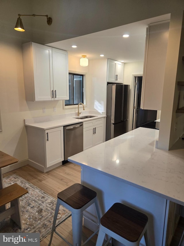 6 Granby Ln, Ocean Pines, MD 21811 - kitchen featuring stainless steel appliances, a sink, light wood-type flooring, white cabinetry, and recessed lighting