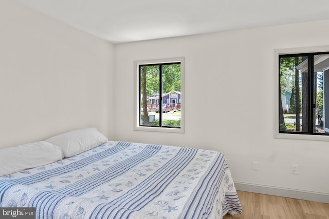 6 Granby Ln, Ocean Pines, MD 21811 - bedroom featuring multiple windows, light wood-type flooring, and baseboards