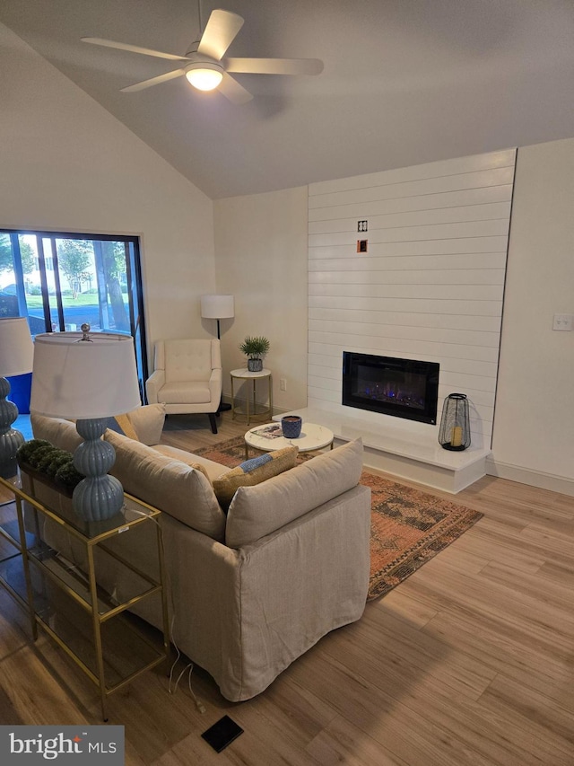 6 Granby Ln, Ocean Pines, MD 21811 - living room featuring wood finished floors, ceiling fan, a fireplace, and vaulted ceiling