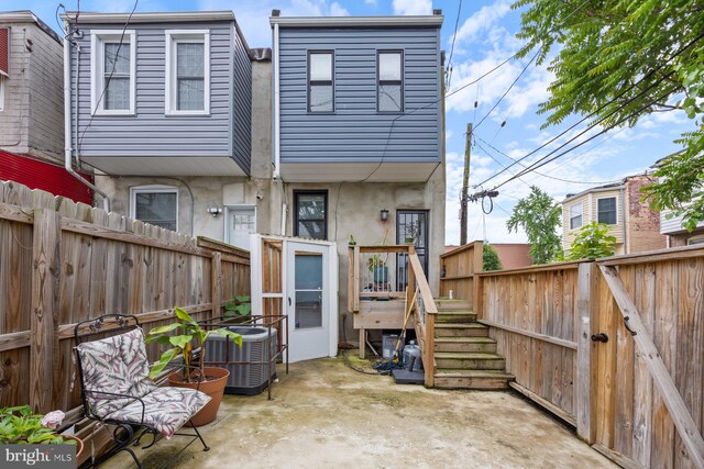 2300 Ashland Ave, Baltimore, MD 21205 - rear view of property with central AC, a fenced backyard, and stucco siding