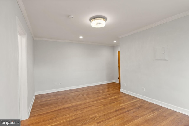 unfurnished room with crown molding, baseboards, light wood-style flooring, recessed lighting, and a smoke detector