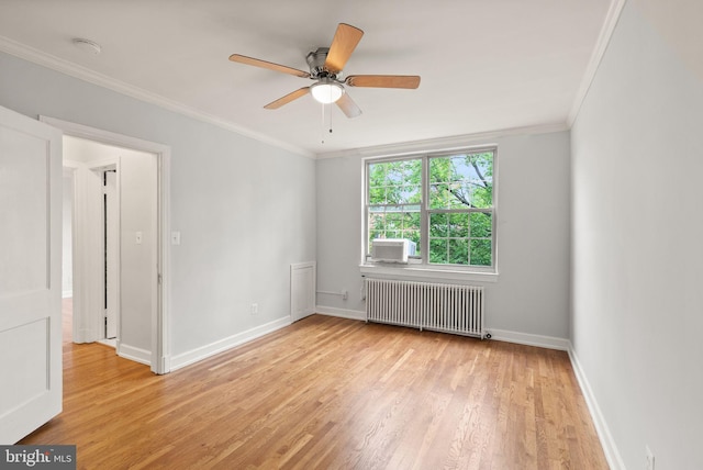 empty room featuring radiator heating unit, light wood-style floors, crown molding, a ceiling fan, and baseboards